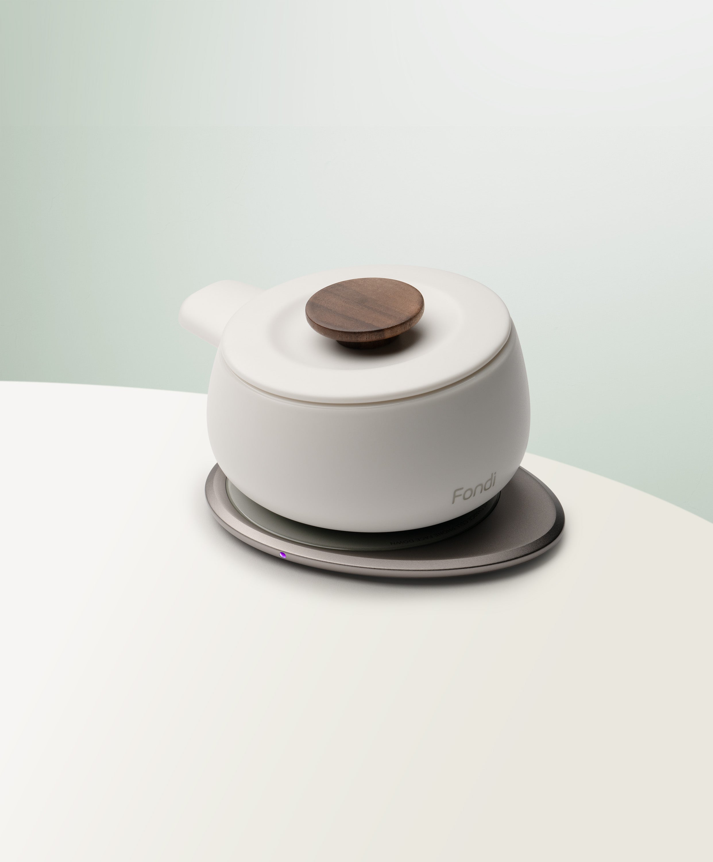 Fondi Self-Heating Ceramic Fondue 7.6 fl oz / 225 mL in Jasmine White angled top-side view on OHOM Charging Pad 3