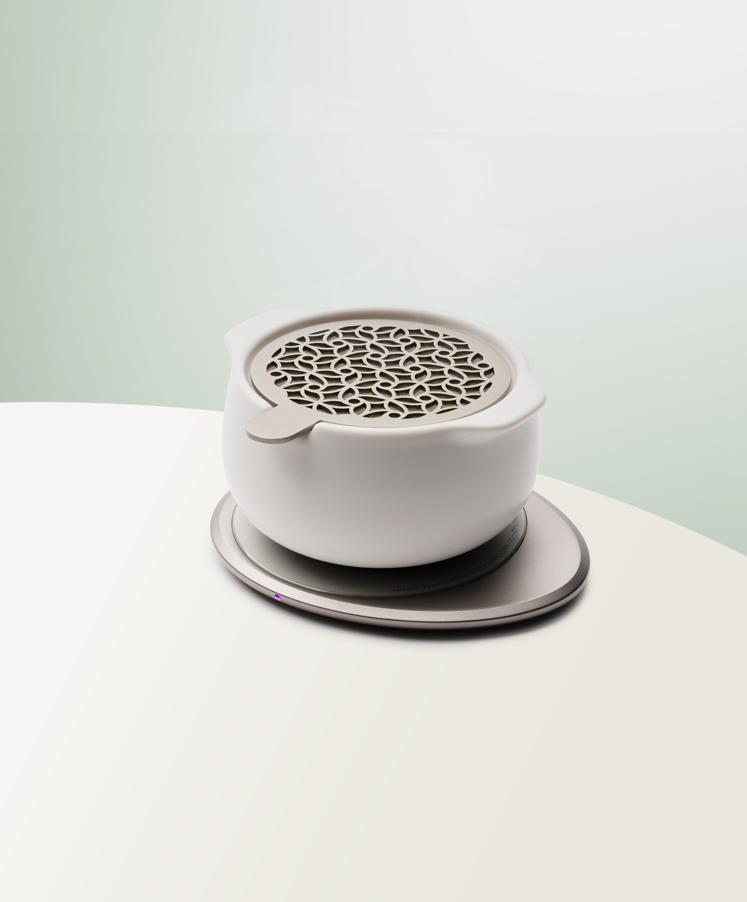 Jun Self-Heating Ceramic Diffuser 5 fl oz / 150 mL with lid in Jasmine White angled view on Ohom Pad 3