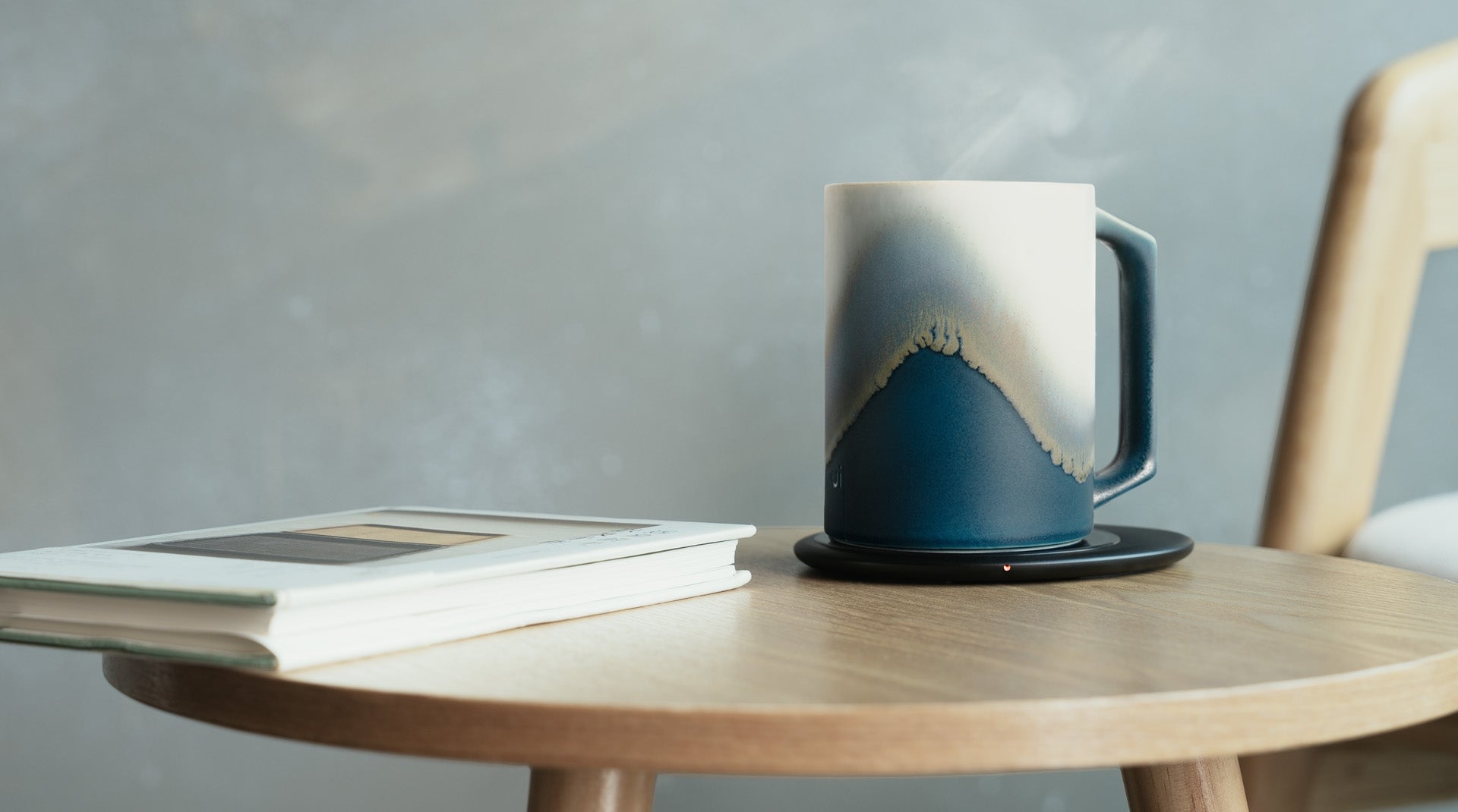 Self heating mug next to book