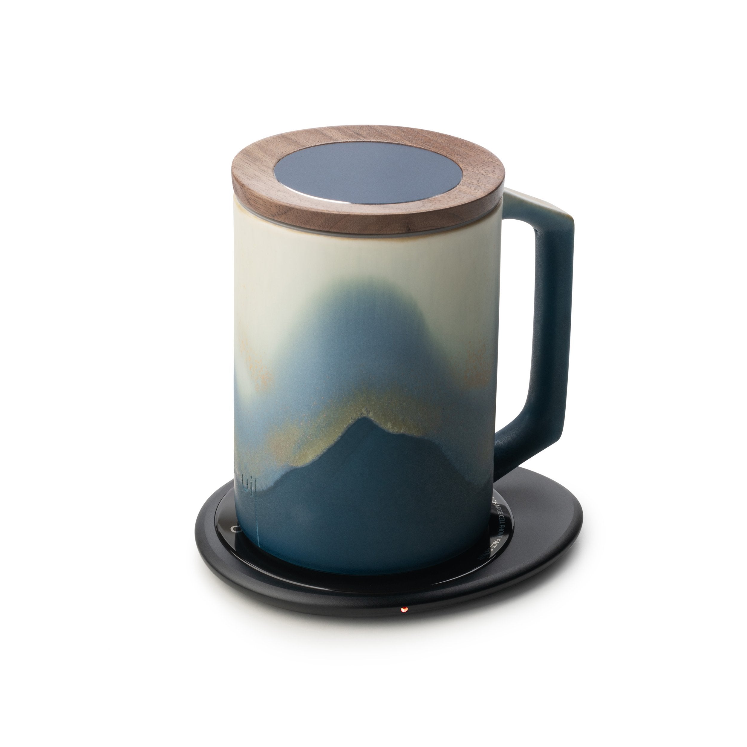 Blue mug with lid designed on black pebble heating pad
