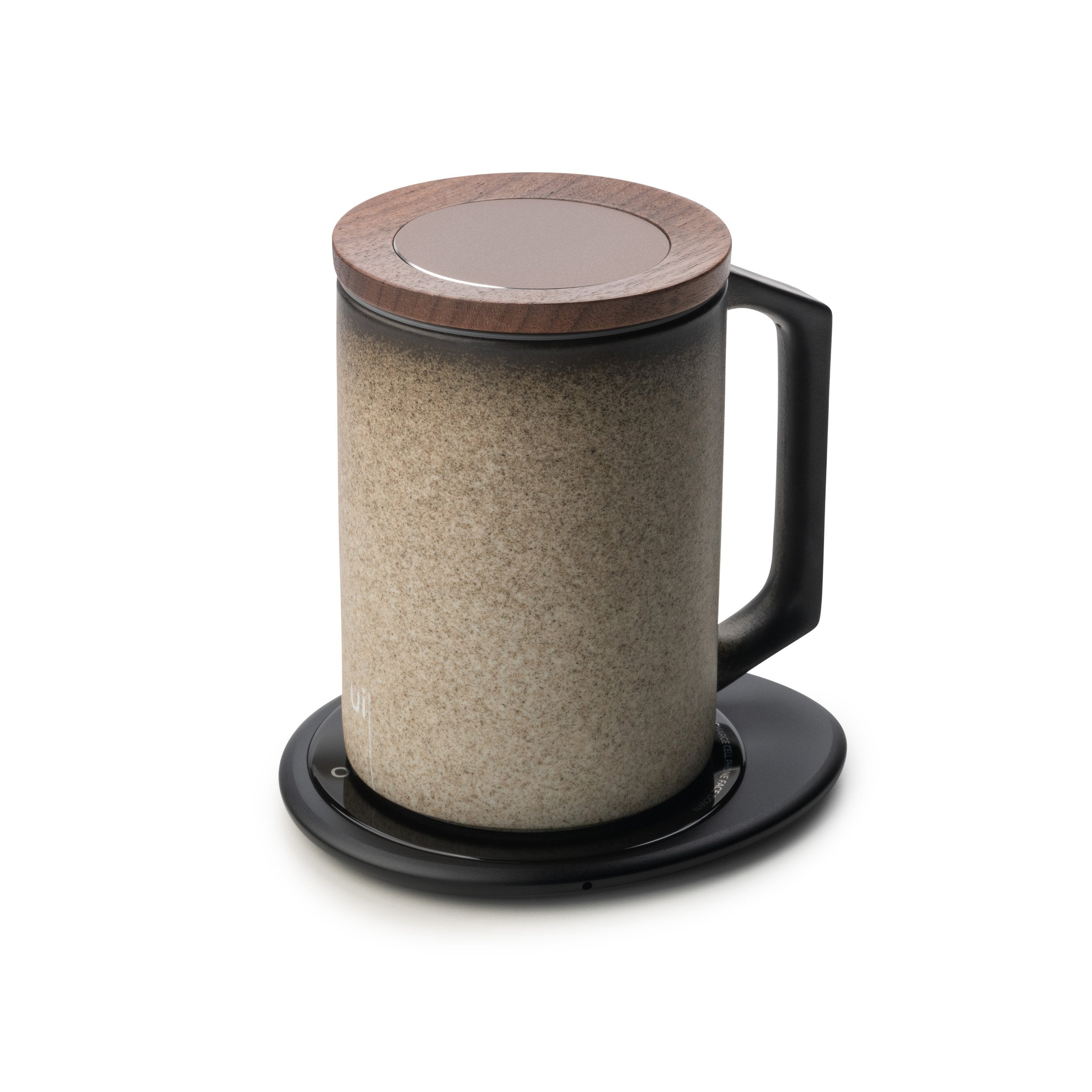 Stone textured mug with lid on black pebble heating pad