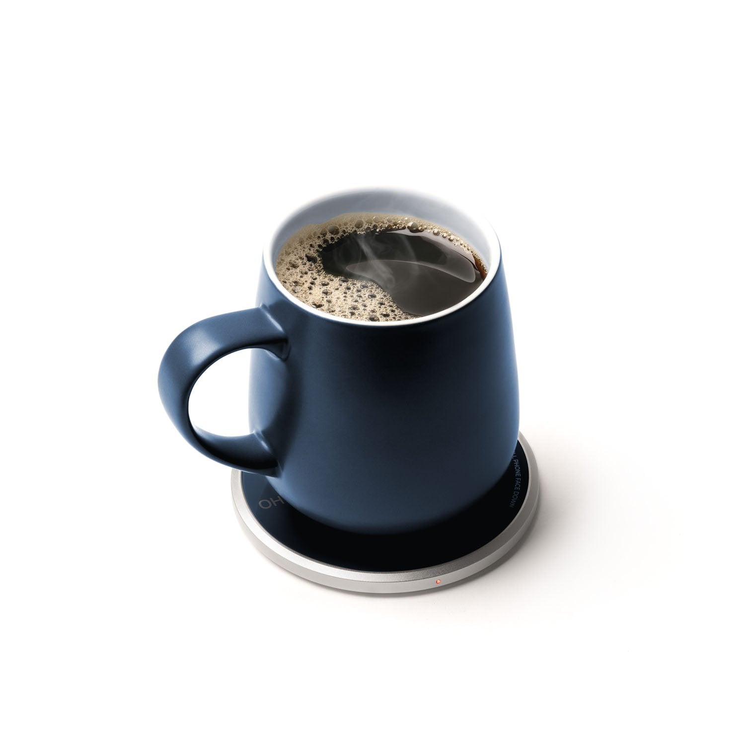 Navy mug with tea on heating pad