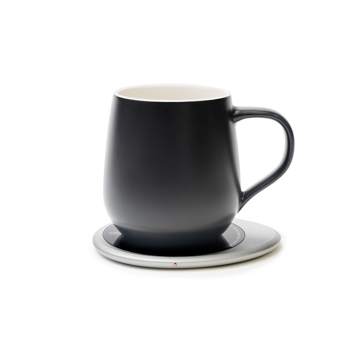 Black mug on black pebble heating pad