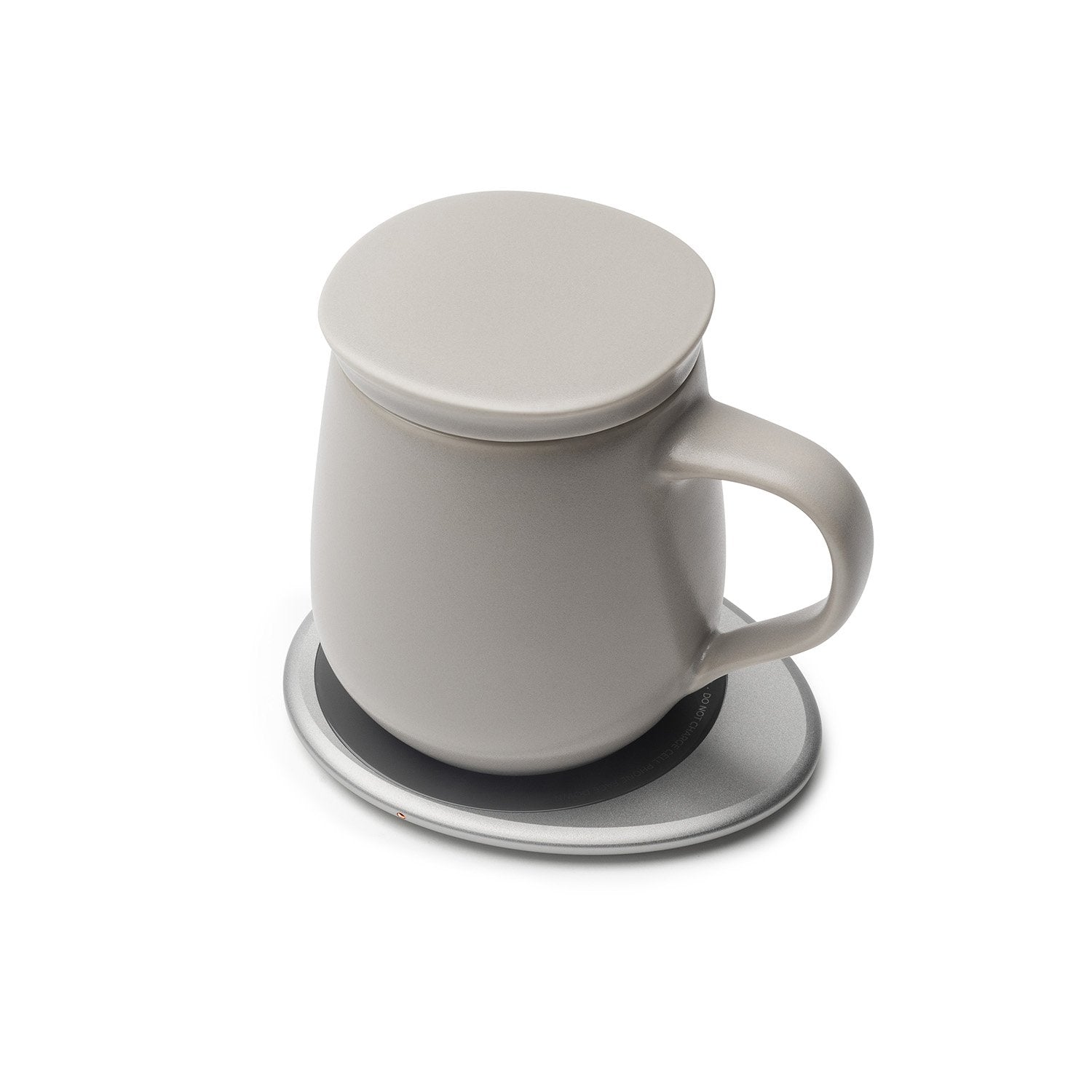 Soft gray mug with lid on heating pad
