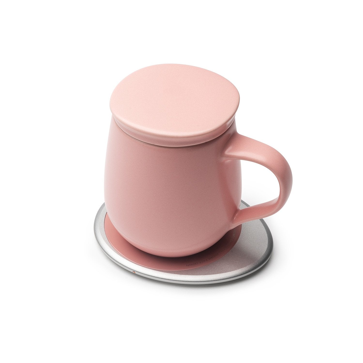 Pink mug with lid on heating pad