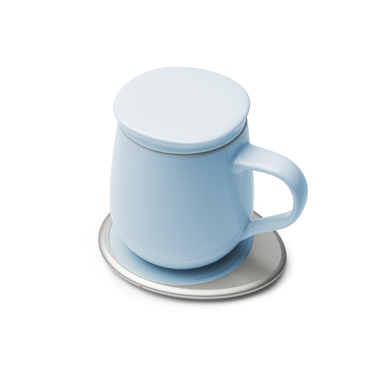 Light blue mug with lid on heating pad