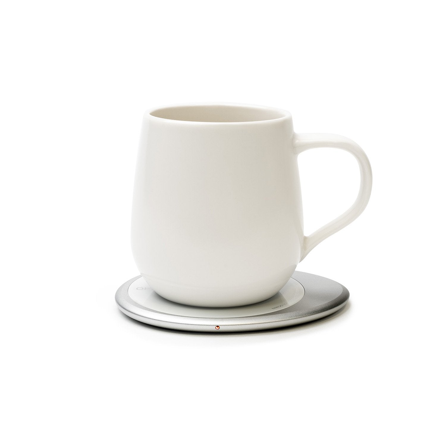 White mug on heating pad