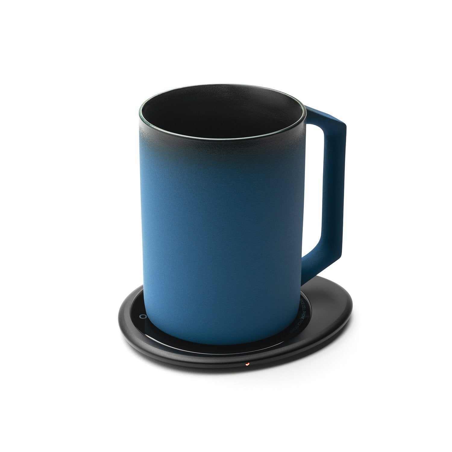 Dark blue mug on black pebble heating pad