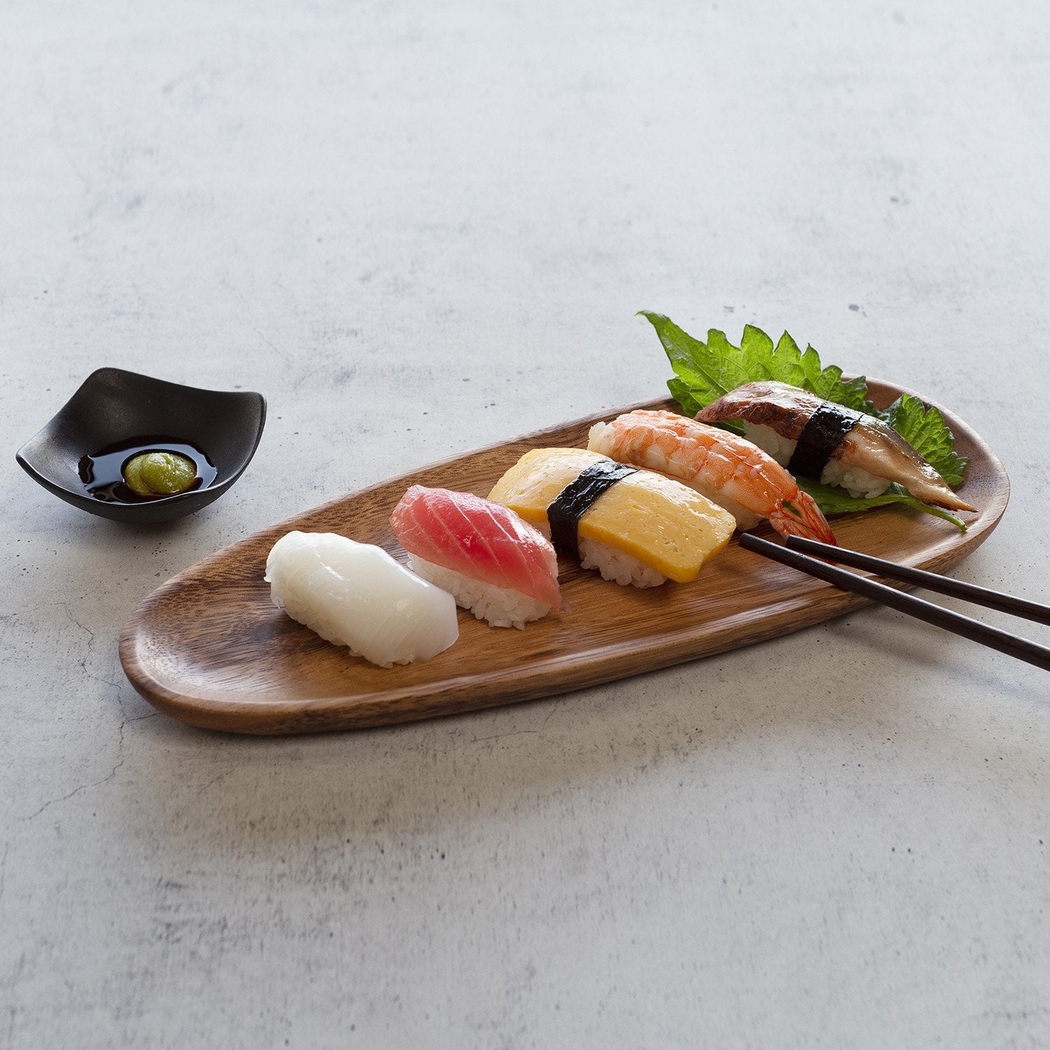 Sushi on large wooden plate