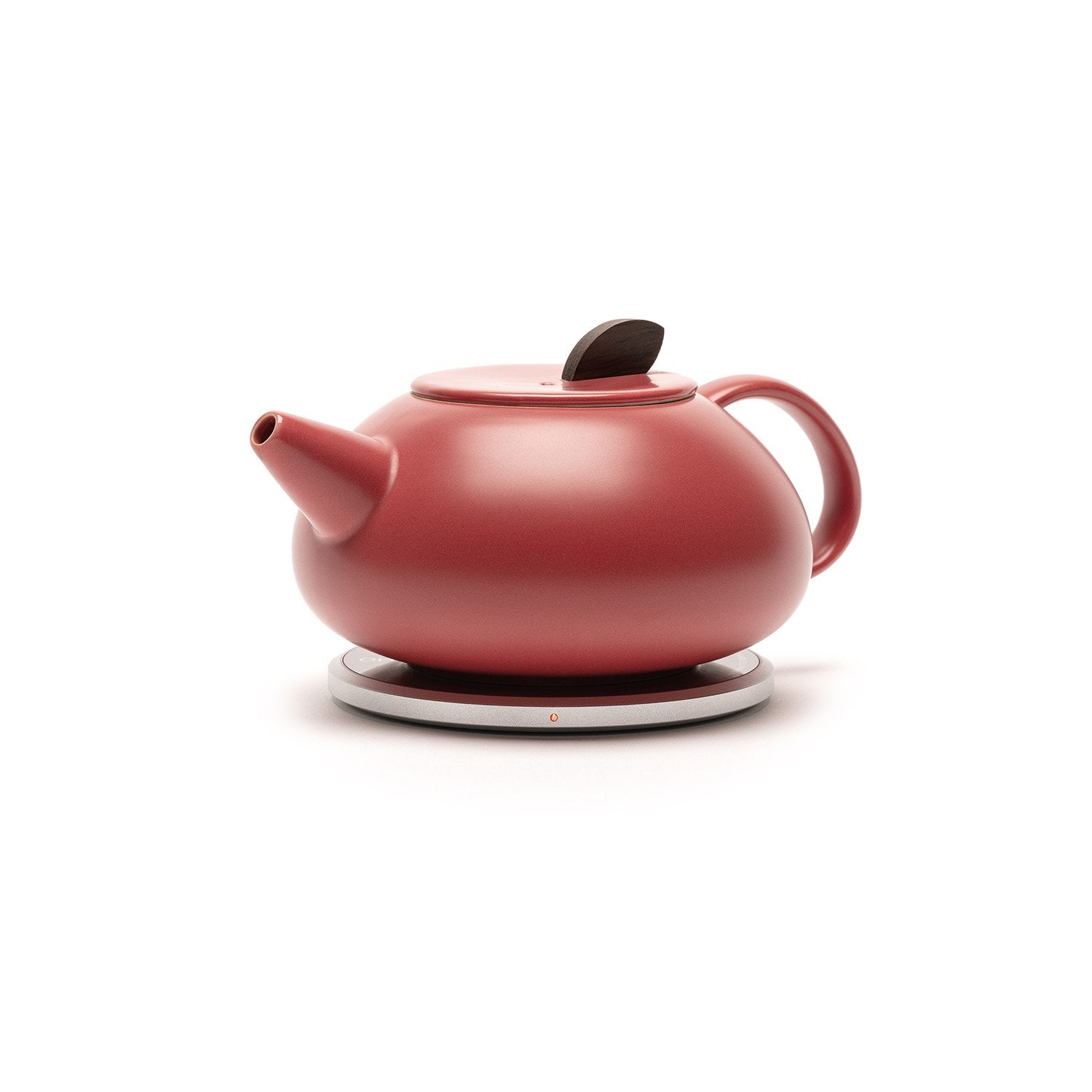 Sideview red teapot on heating pad