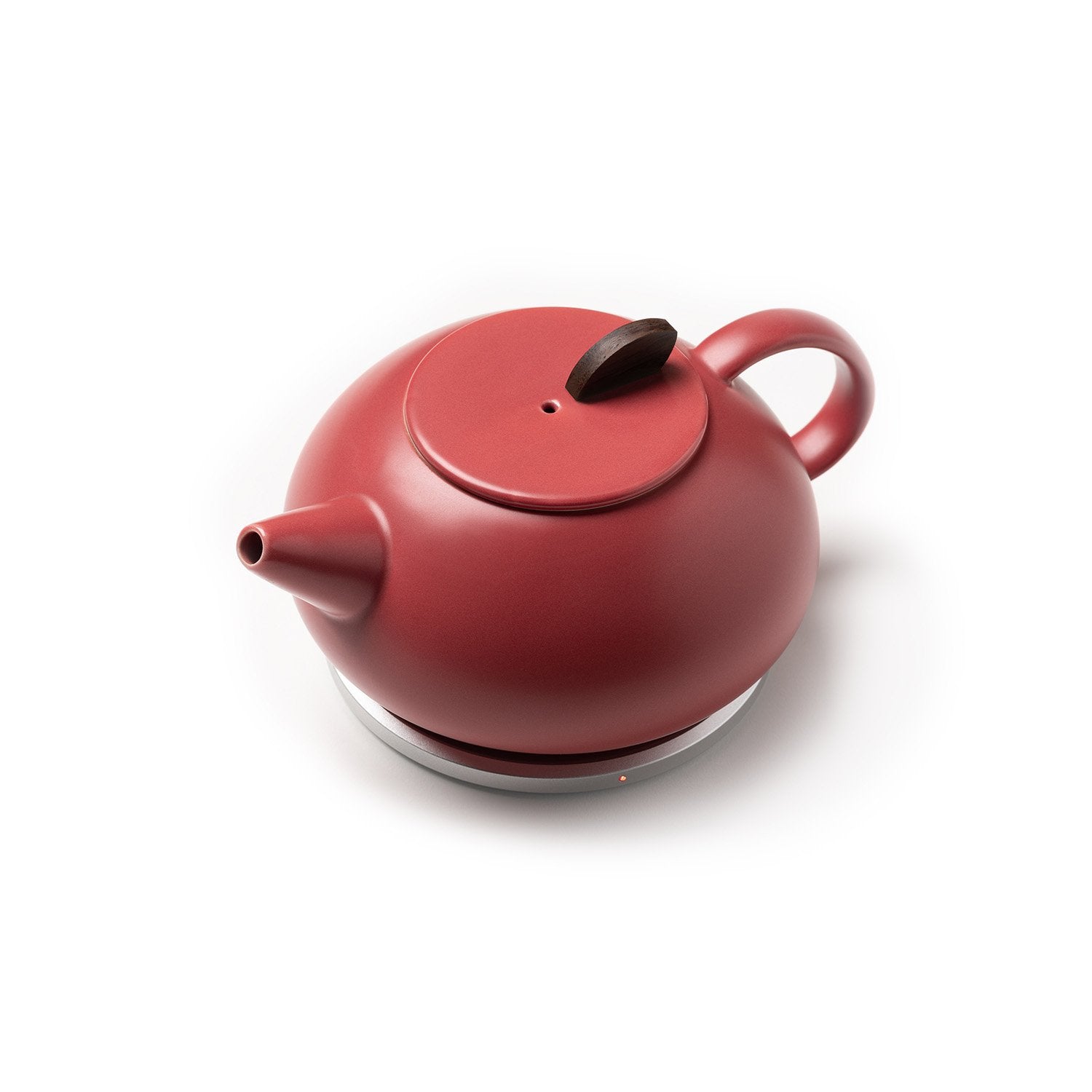 Top view of red teapot on heating pad