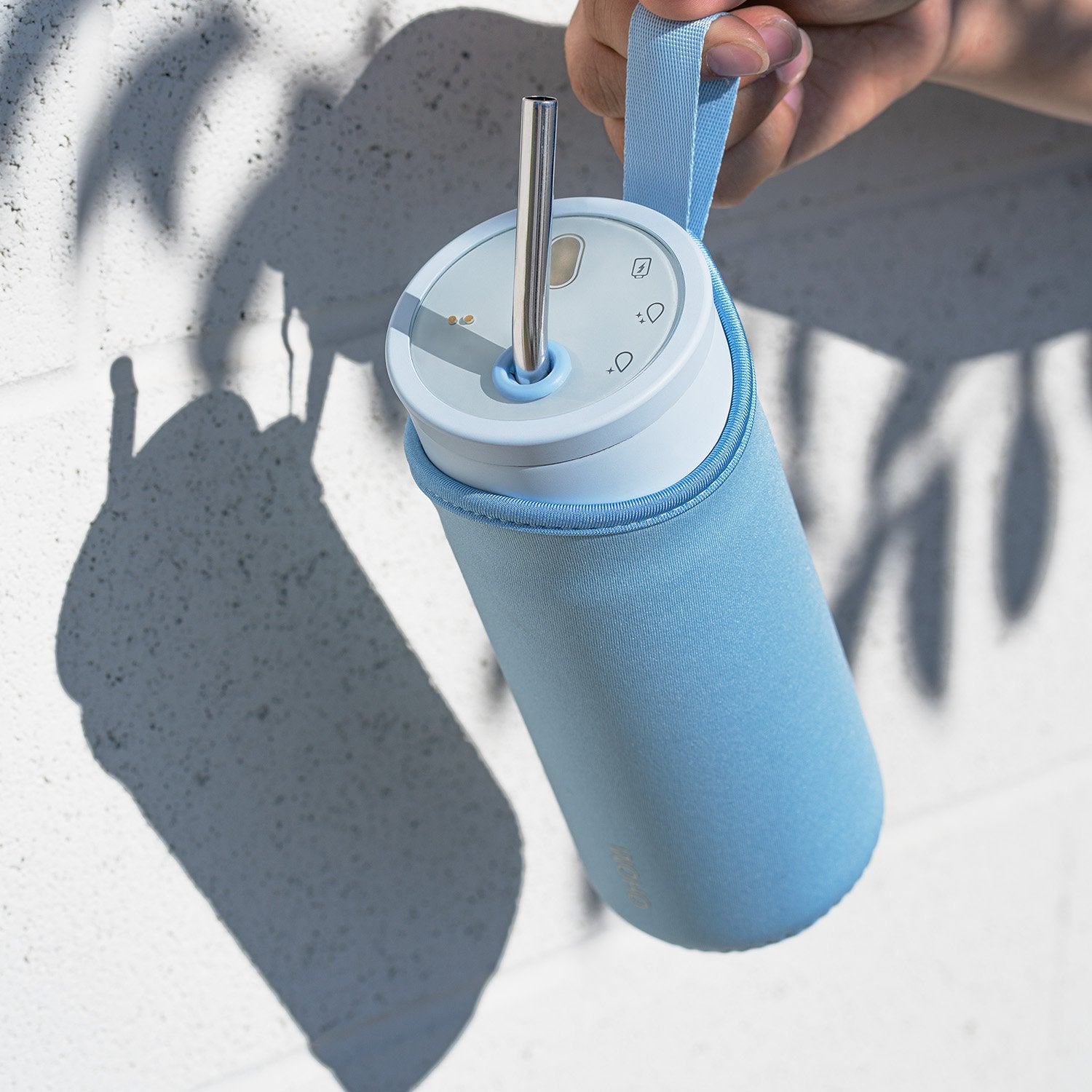 Hand holding light blue pouch with light blue bottle